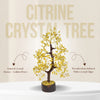 Citrine crystal tree with text describing its components on a beige background