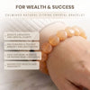 Calminds natural citrine crystal bracelet on a wrist with text about its benefits.