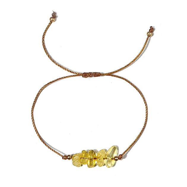 Bracelet with yellow beads on a white background