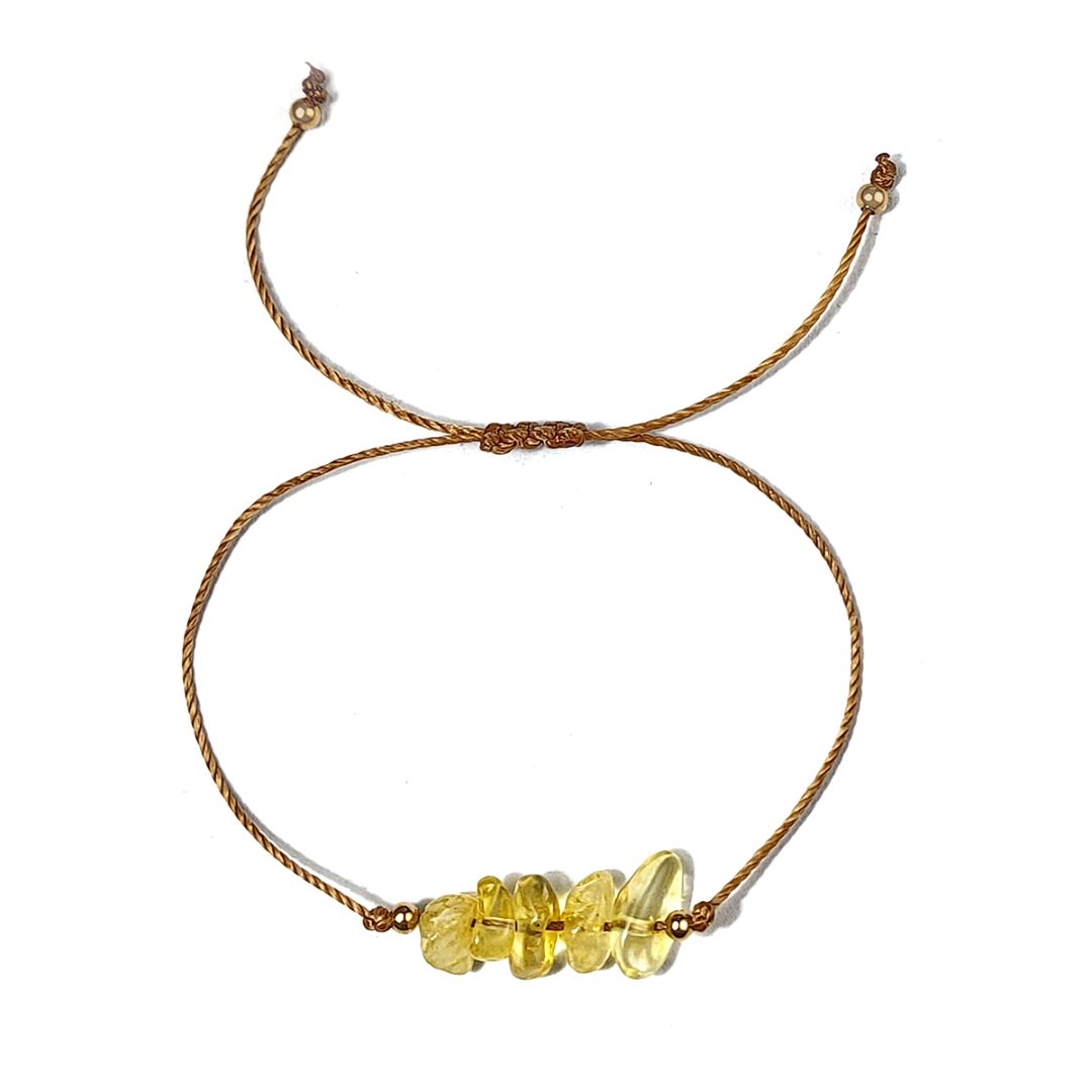 Bracelet with yellow beads on a white background