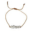 thread bracelet with clear crystal beads on a white background