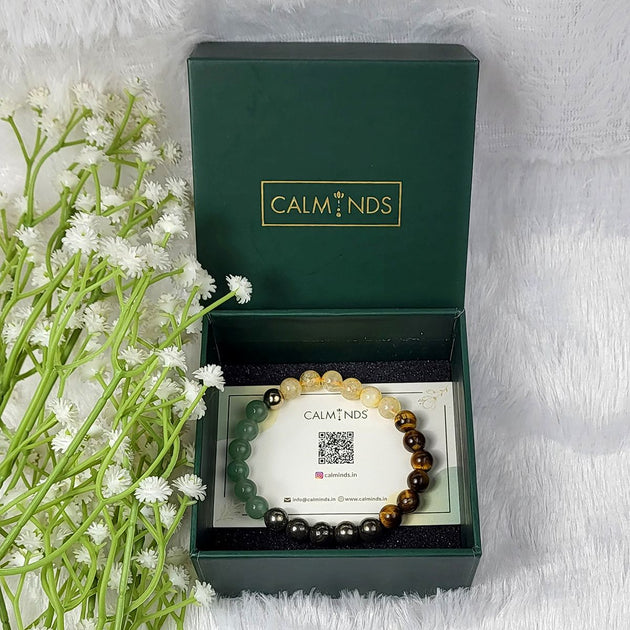 Crystal money bracelet in a calminds box with flowers on a white background