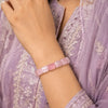Cylindrical rose quartz bracelet worn on wrist