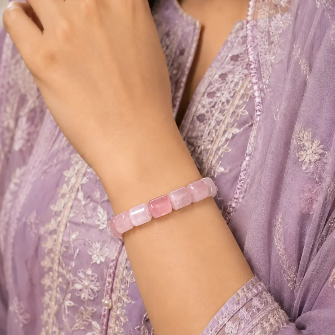 Cylindrical rose quartz bracelet worn on wrist