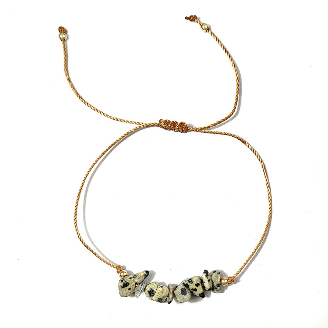 bracelet with dalmatian jasper stone beads on a white background