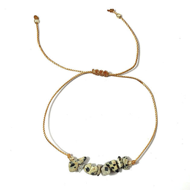 bracelet with dalmatian jasper stone beads on a white background