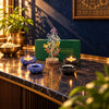 7 chakra crystal tree with blue lapis and black tourmaline tea light holders on a marble counter