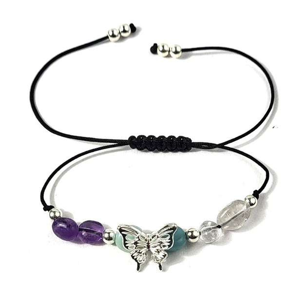 bracelet with butterfly charm and beads on a white background