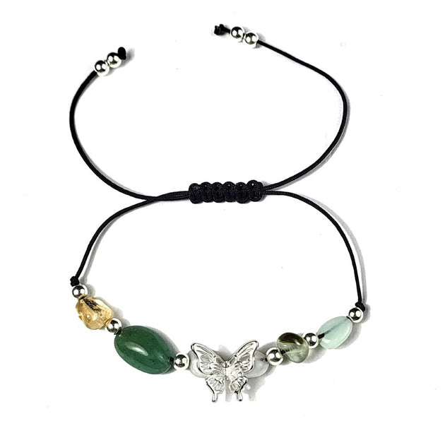 Bracelet with beads and a butterfly charm on a white background