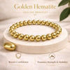 Gold beaded bracelet on a white platform with text about its benefits.