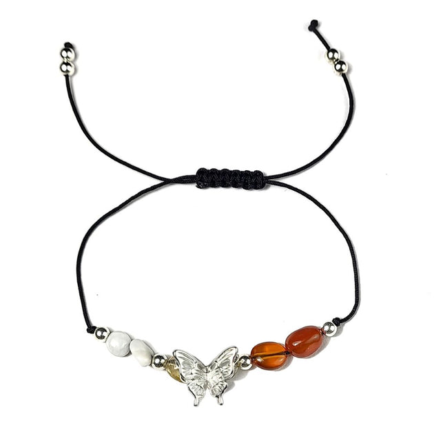 Bracelet with butterfly charm and beads on a white background