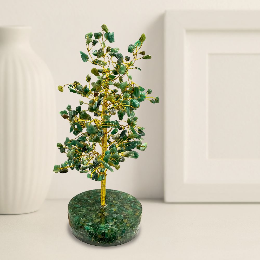 Decorative tree made of green stones and gold branches on a white background