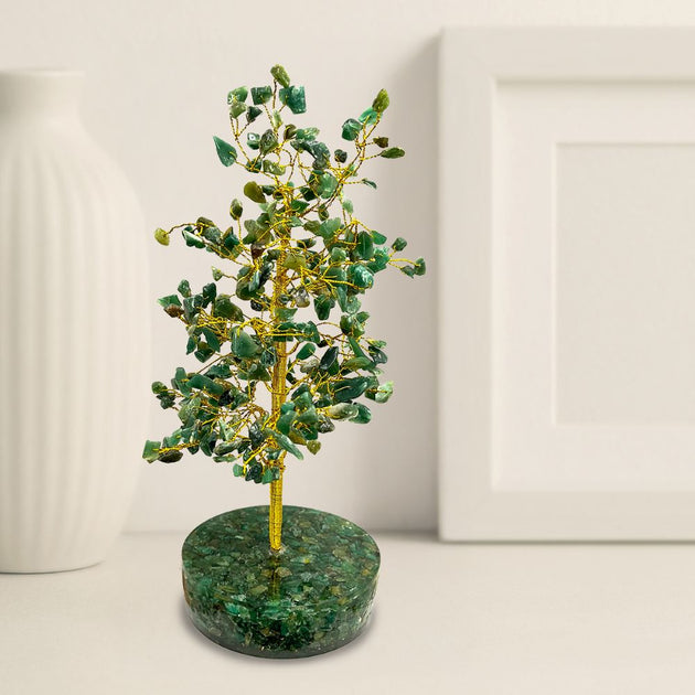 Decorative tree made of green stones and gold branches on a white background