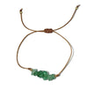 green avnturine crystal thread bracelet on a white surface