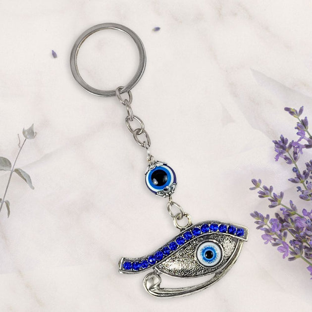 Keychain with eye design on a white background with lavender flowers