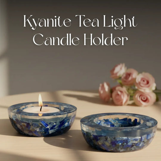Kyanite tea light candle holder with a lit candle on a neutral background