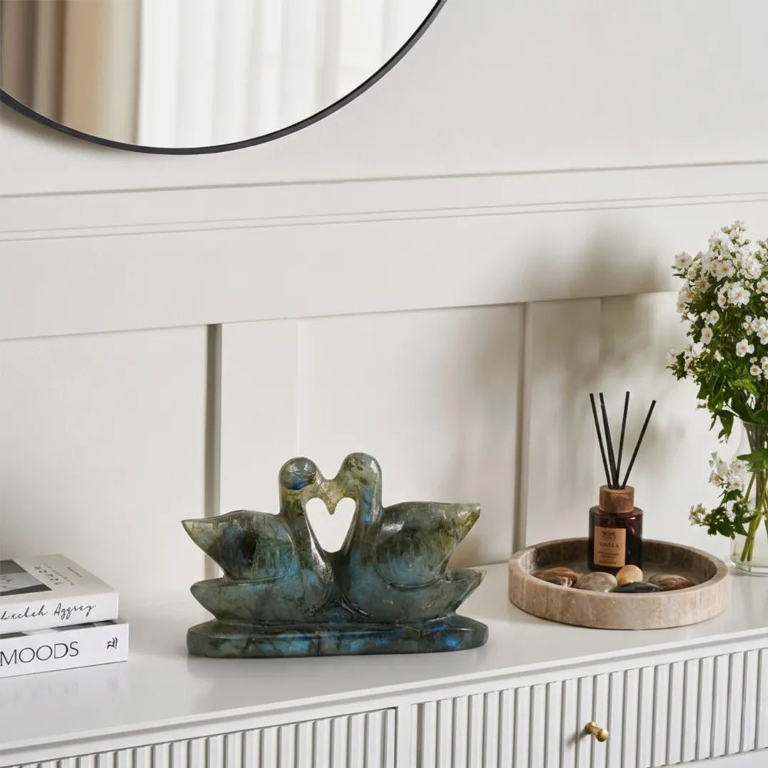 Decorative items on a white surface with a mirror in the background