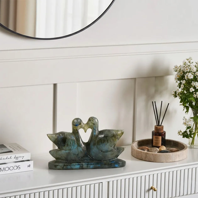 Decorative items on a white surface with a mirror in the background