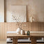 Dining room with wooden table, vases, and wall art in a neutral color scheme.