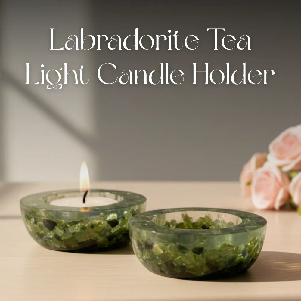 Two Labradorite tea light candle holders with a lit candle on a neutral background.