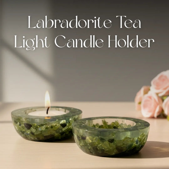 Two Labradorite tea light candle holders with a lit candle on a neutral background.