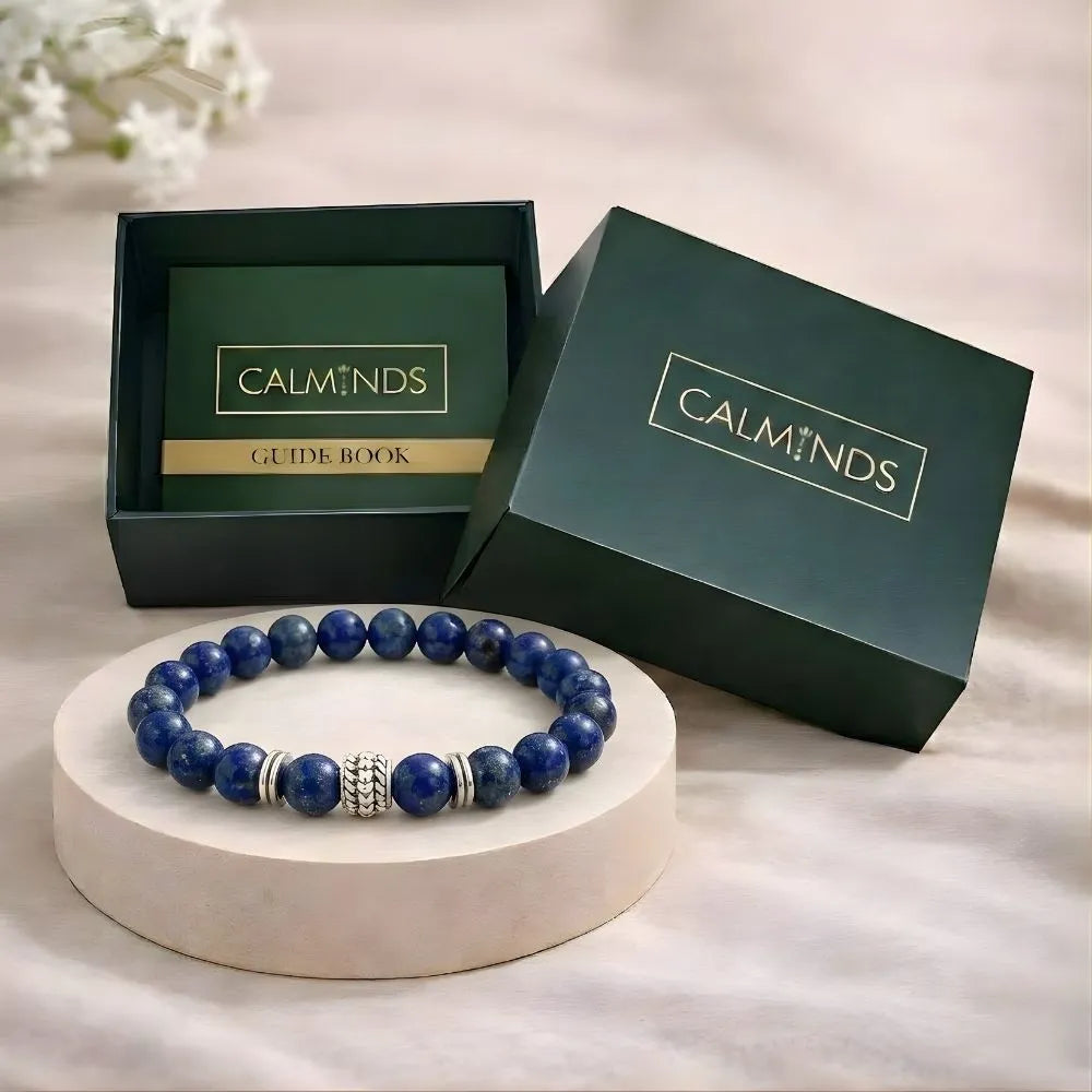 Blue beaded bracelet on a white stand with 'Calminds' branded box in the background