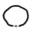 Black beaded bracelet with a blue evil eye charm on a white background