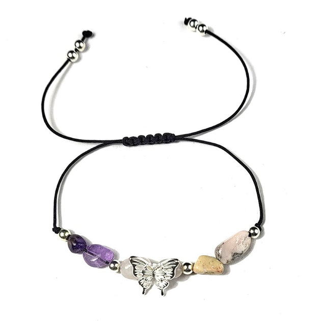 Necklace with butterfly charm and beads on a white background