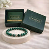 Green beaded bracelet on a white stand with 'CALMINDS' branded box in the background.