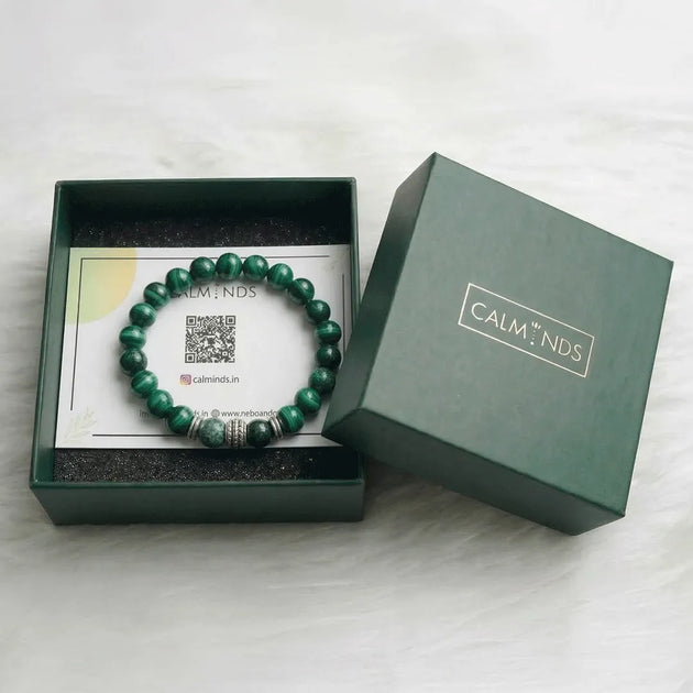 Green beaded bracelet in a 'Calm N'ds' branded box on a white background