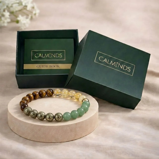 Beaded bracelet on a stand with 'CALMINDS' branded box in the background