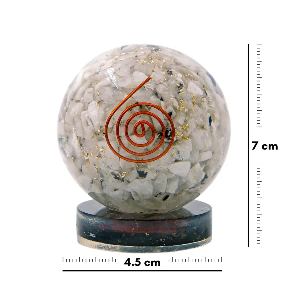 Crystal sphere with spiral design on a stand, accompanied by measurement scale.