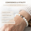 White beaded crystal bracelet on a wrist with text about its benefits.