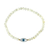 white bracelet with a blue evil eye charm on a white background
