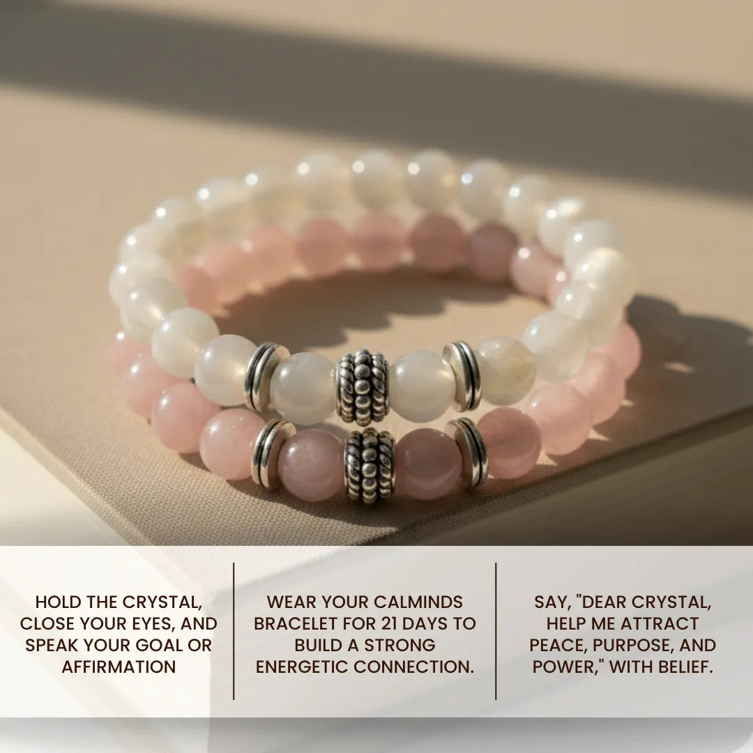Stack of beaded bracelets with silver beads on a beige surface