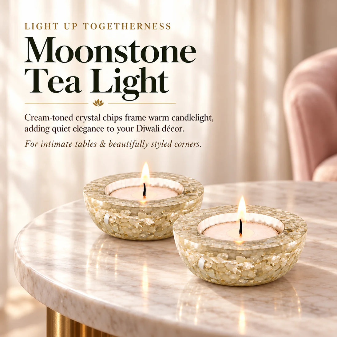 Two moonstone tea light holders with cream crystal chips and lit candles on a marble table