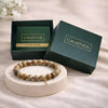 Bracelet on a round stone platform with 'CALMINDS' branded box in the background