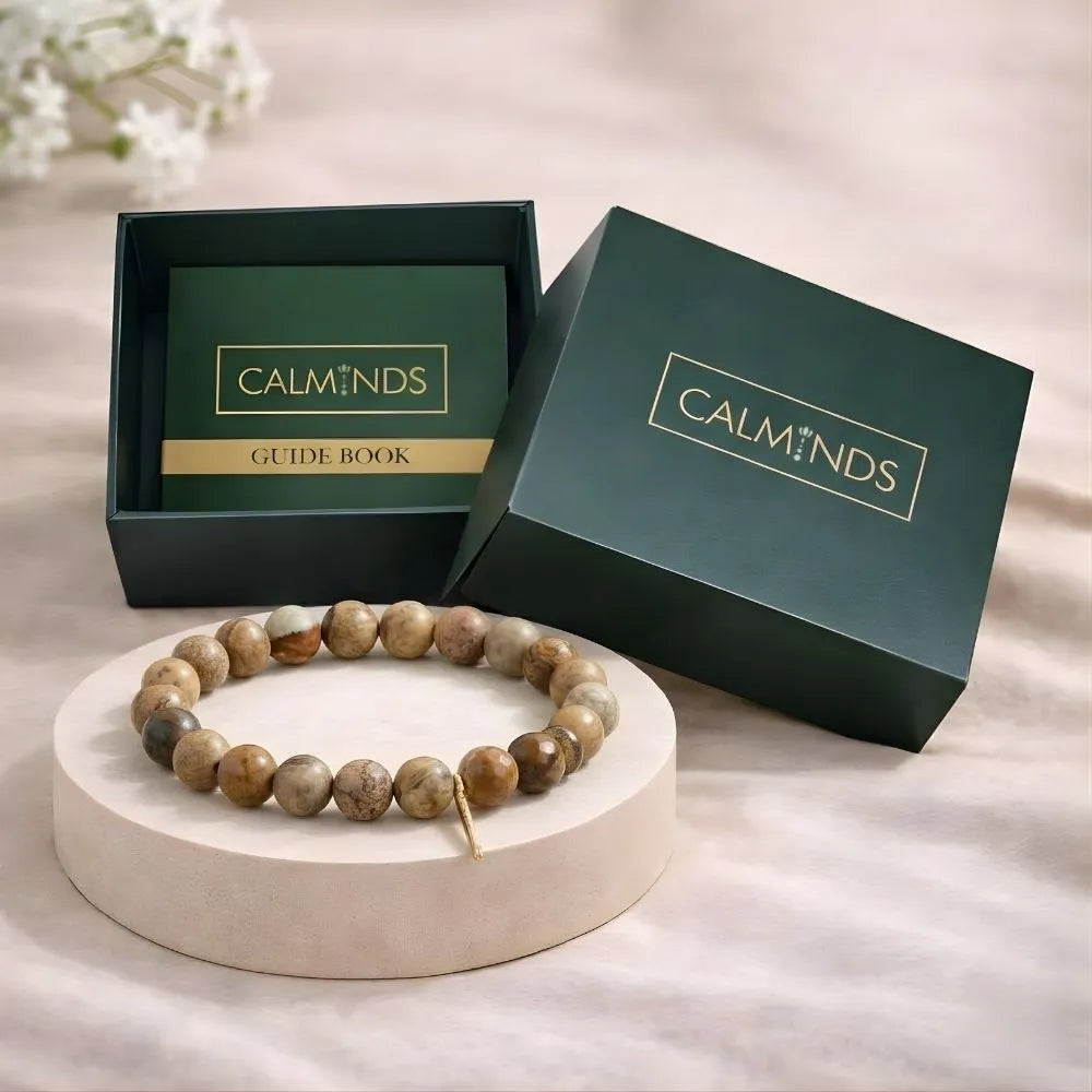 Bracelet on a round stone platform with 'CALMINDS' branded box in the background