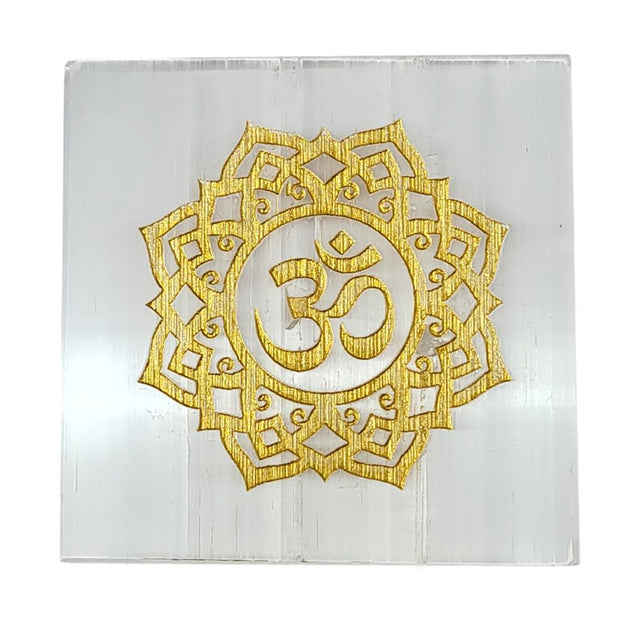 decorative selenite plate with golden om design on a white background