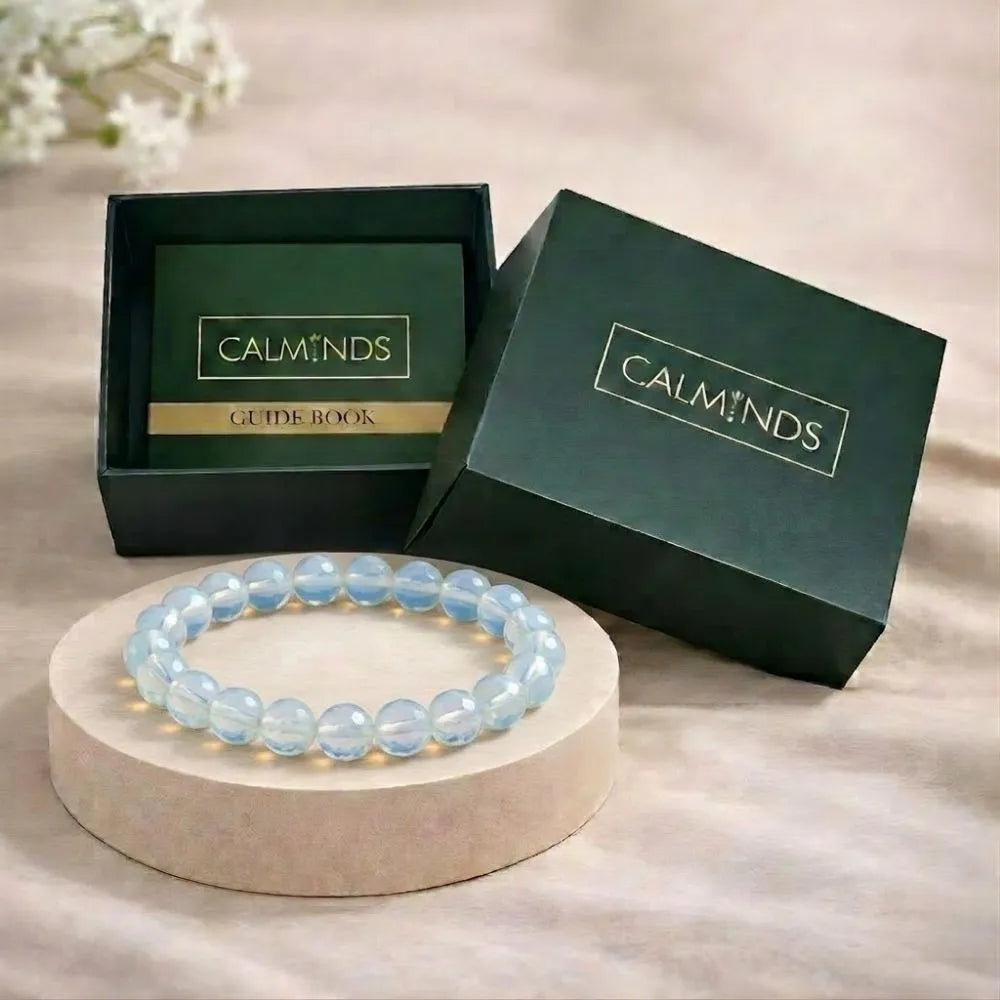 Blue beaded bracelet on a stand with 'Calminds' branded box in the background