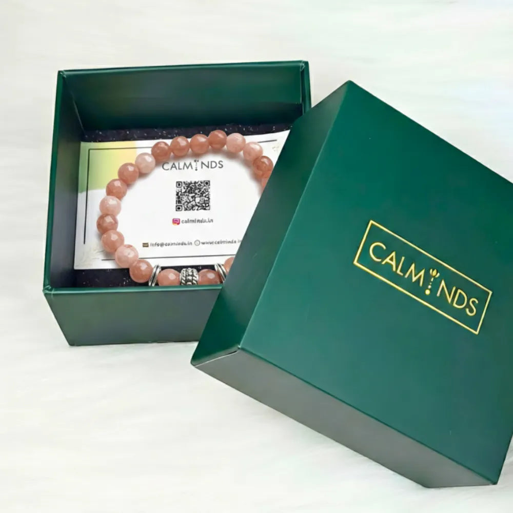 Green box with a 'Calm Minds' bracelet and packaging on a white background