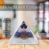 Pyramid-shaped crystal with labeled benefits on a wooden surface