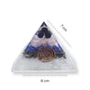 Triangular crystal with spiral design and measurement scale on a white background