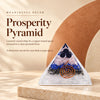 Clear orgonite pyramid with layered crystal chips and a copper spiral