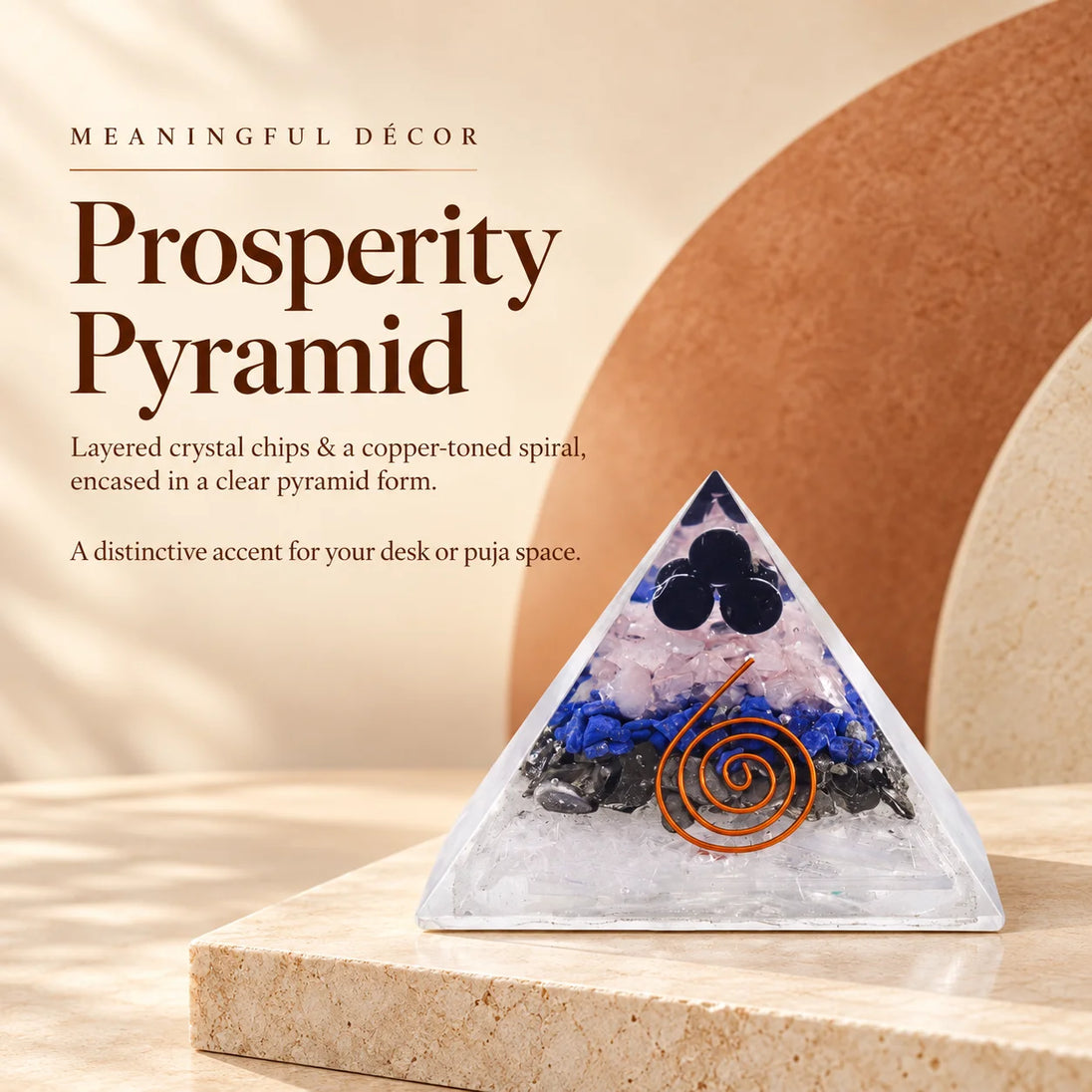 Clear orgonite pyramid with layered crystal chips and a copper spiral