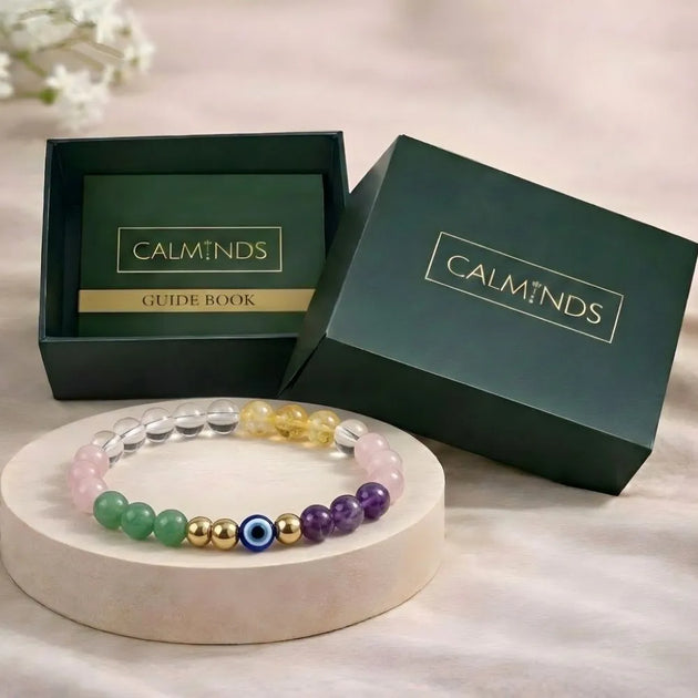 Colorful beaded bracelet on a white stand with 'Calminds' branded box in the background.