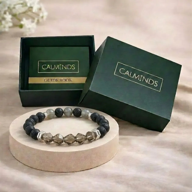 Beaded bracelet on a stand with 'CALMINDS' branded box in the background