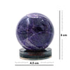 Purple crystal sphere on a stand with measurement scale