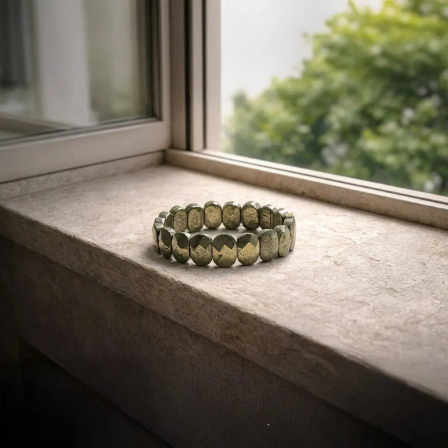 Green beaded bracelet on a windowsill with natural light