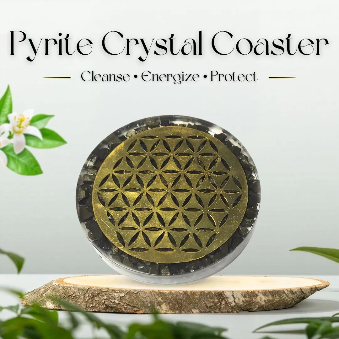 Pyrite crystal coaster with geometric design on a wooden base, surrounded by greenery.